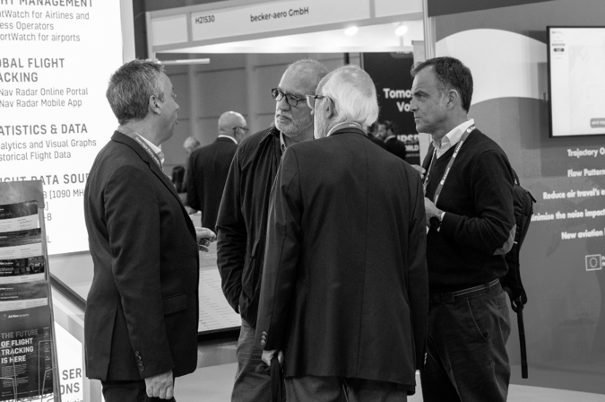 AirNav Systems representatives meeting at an aviation industry event.